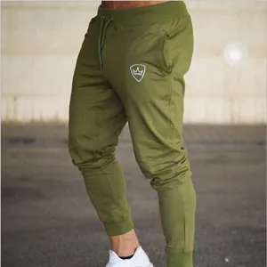 Detail view of army green slim fit men's joggers featuring drawstring waist and logo