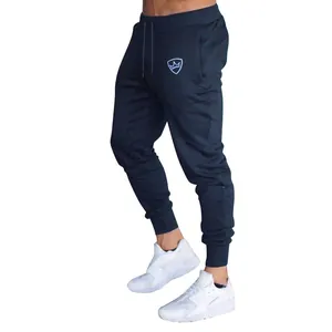 Navy blue men's slim fit drawstring joggers featured in a stylish fitness look
