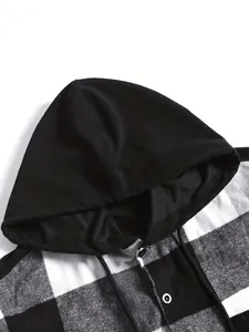 Close-up of the hood and texture of a men's thickened black and white plaid shirt