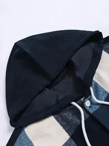 Close-up detail of thickened plaid hooded shirt featuring corduroy hood and drawstring