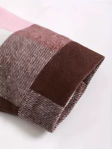 Detailed close-up of a thick men's plaid shirt sleeve showing warm fabric texture and pattern