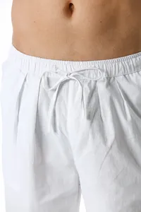 Detailed macro view of white cotton linen men's casual pants showing drawstring waist