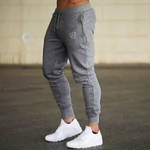 Grey men's slim-fit joggers with drawstring waist and ribbed cuffs for athletic wear