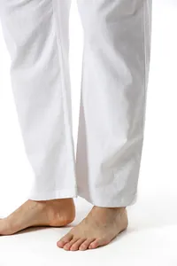 Detailed view of white cotton linen men's pants showing breathable fabric texture