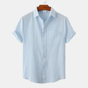 Detailed macro view of a light blue linen short-sleeved shirt with a functional breast pocket