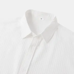 Close-up of white textured seersucker shirt collar with M size tag
