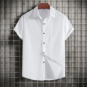 Close-up of white short-sleeved men's shirt with textured fabric and black buttons