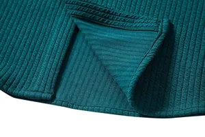 Detailed macro view of dark green ribbed knit fabric texture with precision stitching