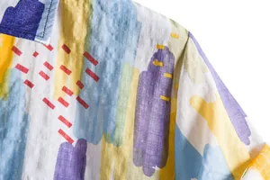 Close-up detail of men's casual shirt with vibrant abstract brushstroke pattern