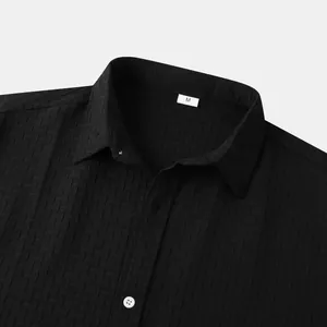 Detailed close-up of a men's black short sleeve shirt featuring jacquard fabric texture