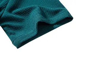 Close-up detail of teal men's short sleeve shirt showing waffle texture and stitching