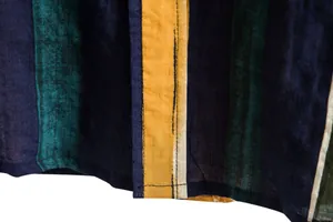Detailed macro view showing the striped fabric texture and stitching of a men's shirt.