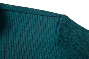 Close-up detail showing the ribbed fabric texture and fine stitching of a teal shirt