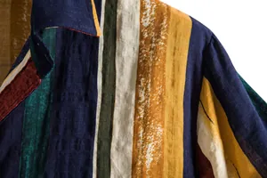 Macro view of textured linen fabric on colorful vertical striped Hawaiian shirt