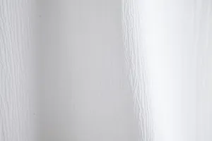 Macro view of breathable white crinkle fabric texture on a casual men's summer shirt