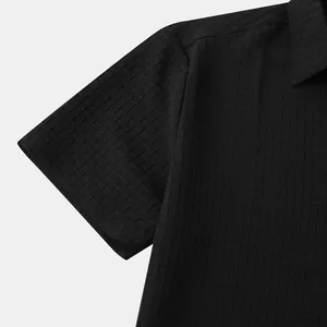 Close-up detail showing the intricate black jacquard fabric texture on a men's summer shirt