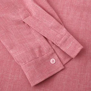 Macro view of the pink cotton linen shirt cuff showing fine texture and button details