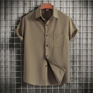 Detailed view of men's casual olive green short sleeve shirt with textured fabric