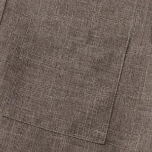 Primer plano de camisa de algodón y lino marrón que muestra bolsillo y textura de tela