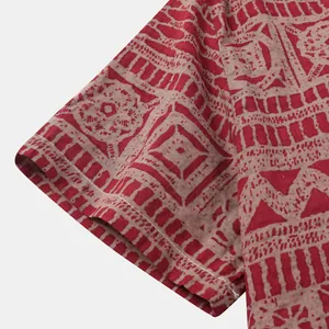 Close-up van de mouw van een etnisch herenoverhemd met een rode tribale print