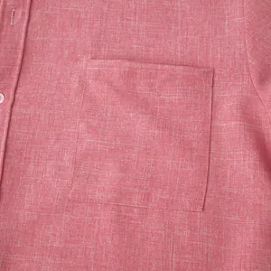 Detailed close-up of the pocket and breathable linen-cotton fabric on a pink men's shirt