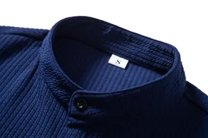 Close-up detail of navy blue textured fabric and band collar on a men's casual shirt.