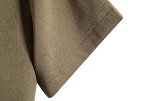 Close-up detail of textured fabric and stitching on a men's casual short sleeve shirt