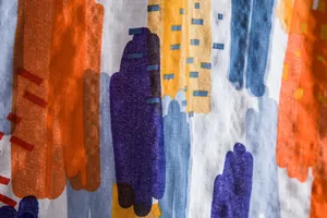 Close-up of abstract colorful brushstroke pattern on men's casual summer shirt fabric