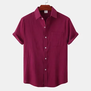 Close-up of burgundy cotton linen shirt showing fabric texture and pocket detail