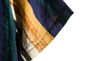 Macro detail of vertical striped men's Hawaii shirt sleeve with visible fabric texture and stitching