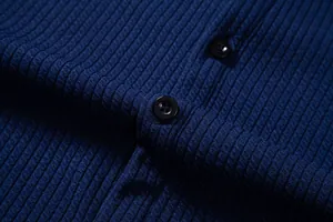 Macro view showing the navy blue ribbed texture and black buttons of a men's casual shirt