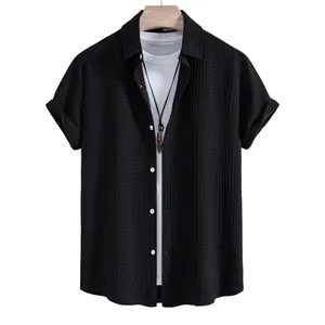 Detailed view of a black men's short-sleeve shirt featuring a unique waffle texture