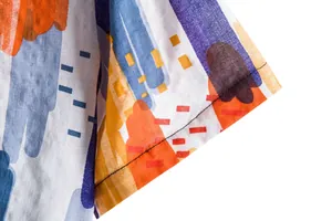 Macro view of abstract colorful print and sleeve stitching on men's summer casual floral shirt