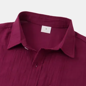 Macro view of maroon cotton linen shirt collar showing fabric texture and M size tag