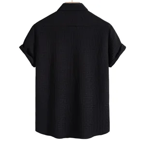 Back view of a men's black short-sleeve shirt featuring a textured waffle weave fabric.