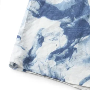 Macro close-up showing the blue and white tie-dye fabric texture and neat hemline stitching