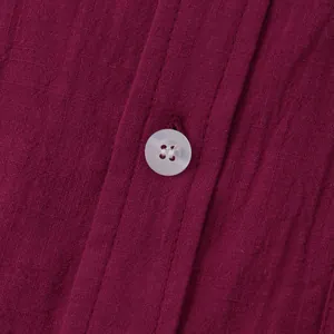 Close-up of maroon cotton linen shirt fabric and white button detail