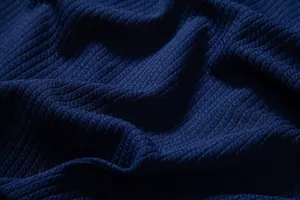 Macro close-up shot showing the detailed navy blue ribbed fabric texture of a casual men shirt
