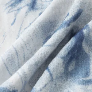 Close-up detail of blue and white tie-dye print fabric for men's Hawaiian shirt