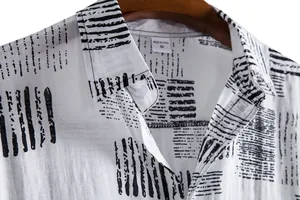 Detail view of men's casual short sleeve shirt with black abstract newspaper pattern