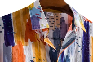 Detailed view of men's summer casual shirt with vibrant abstract brushstroke print