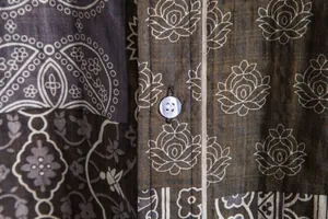 Close-up of button and floral pattern on men's casual short sleeve shirt