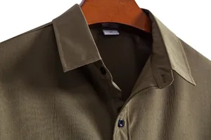 Close-up detail of olive green men's casual shirt collar showing fabric texture