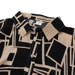 Close-up detail of a men's short sleeve casual shirt with black geometric pattern