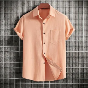 Close-up of the textured fabric and pocket on a peach men's casual short sleeve shirt