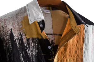Detailed view of the collar and linen texture of a men's abstract printed short sleeve shirt