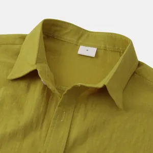 Macro view showing the texture and collar detail of a mustard yellow linen shirt size M