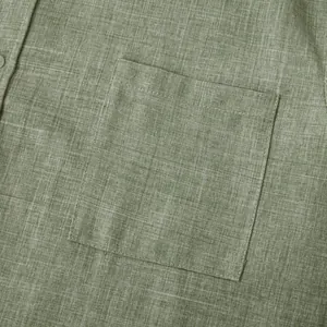 Close-up detail of a men's olive green cotton linen shirt showing pocket and texture