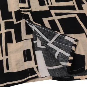 Macro detail view of the bold geometric print and fine stitching on a men's shirt fabric