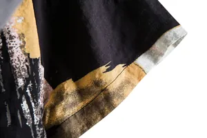 Macro detail of the floral shirt sleeve cuff showing fabric texture and stitching